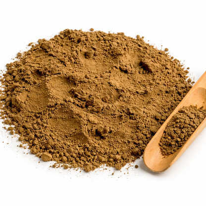 Brown hojicha powder with a wooden scoop on a white background